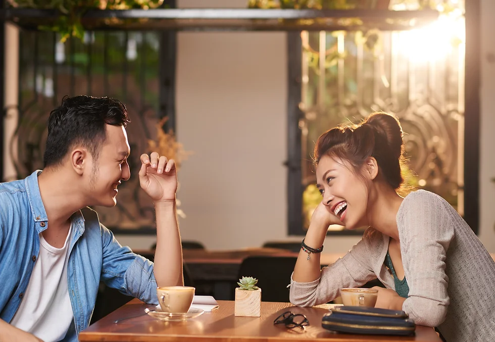 hero: man and woman talking and laughing on date